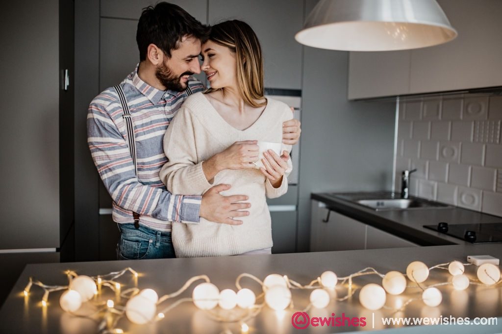 A beautiful young couple is having a romantic moment in their home